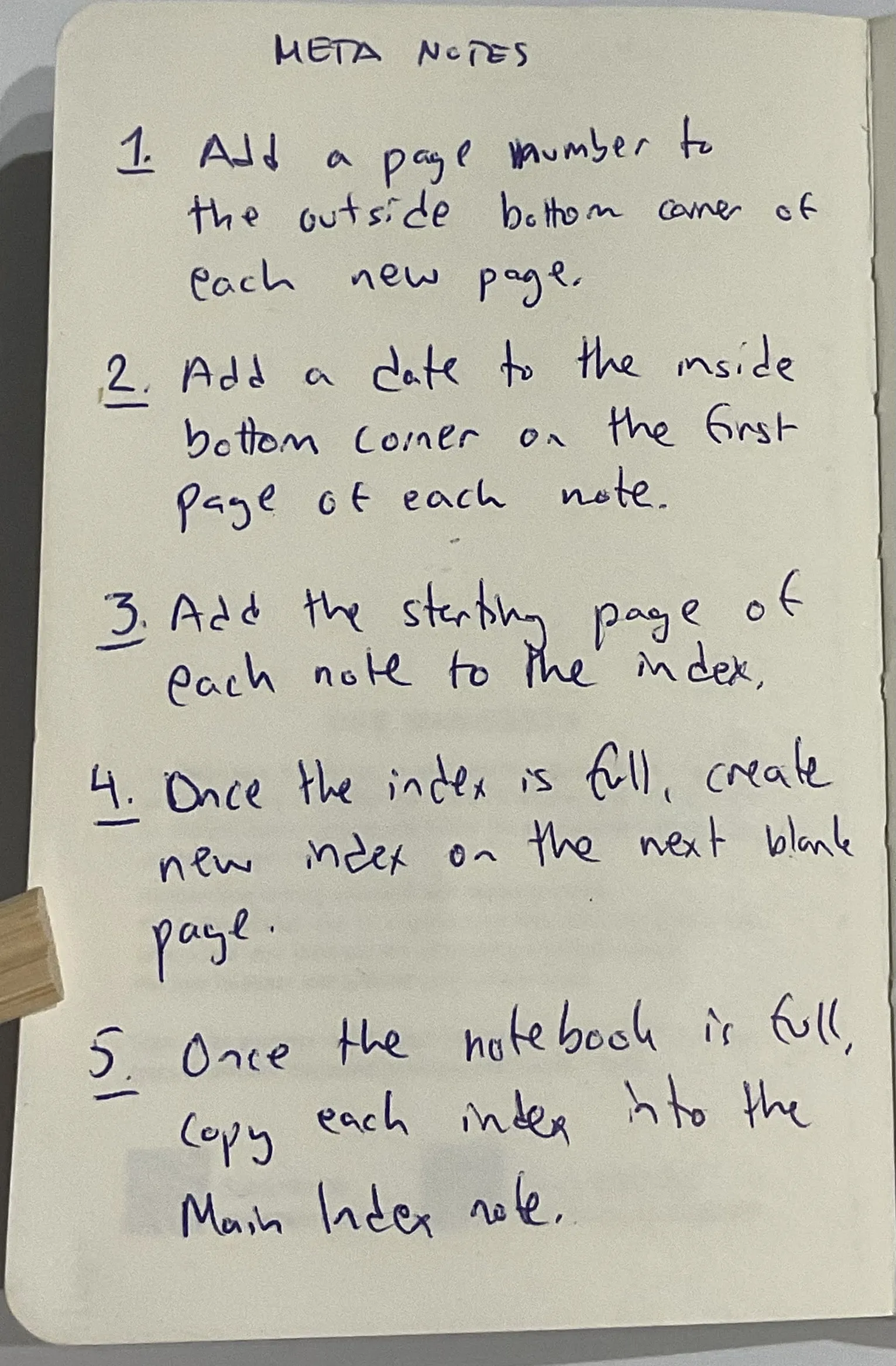Page from my notebook titled Meta Notes with five rules: 1. Add a page number to the outside bottom corner of each
    new page. 2. Add a date to the inside bottom corner on the first page of each note. 3. Add the starting page of each note
    to the index. 4. Once the index is full, create new index on the next blank page. 5. Once the notebook is full, copy each
    index into the Main Index note. 