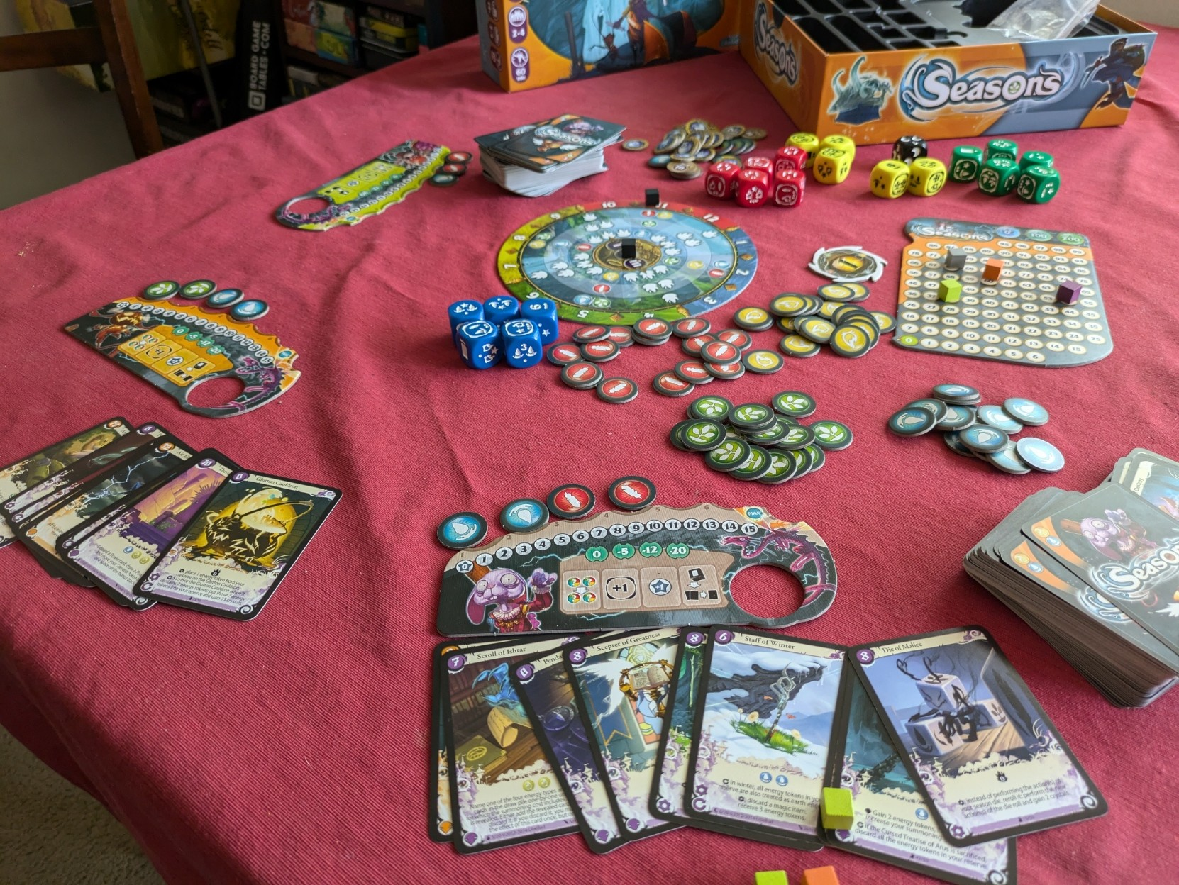 On-going game four player game of Seasons with a variety of cards played and energy tokens collected.