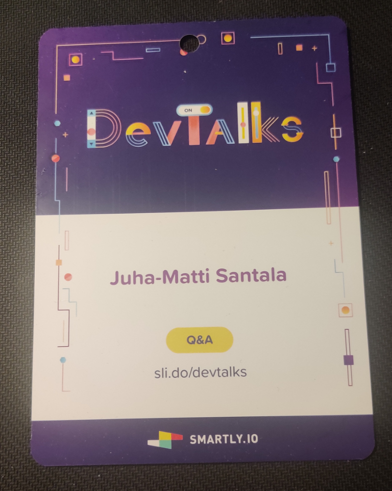 A meetup badge for Smartly DevTalks with my name and a URL to Slido for Q&A