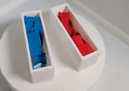 Two narrow white 3D printed containers, filled with small blue and red wooden tokens. 