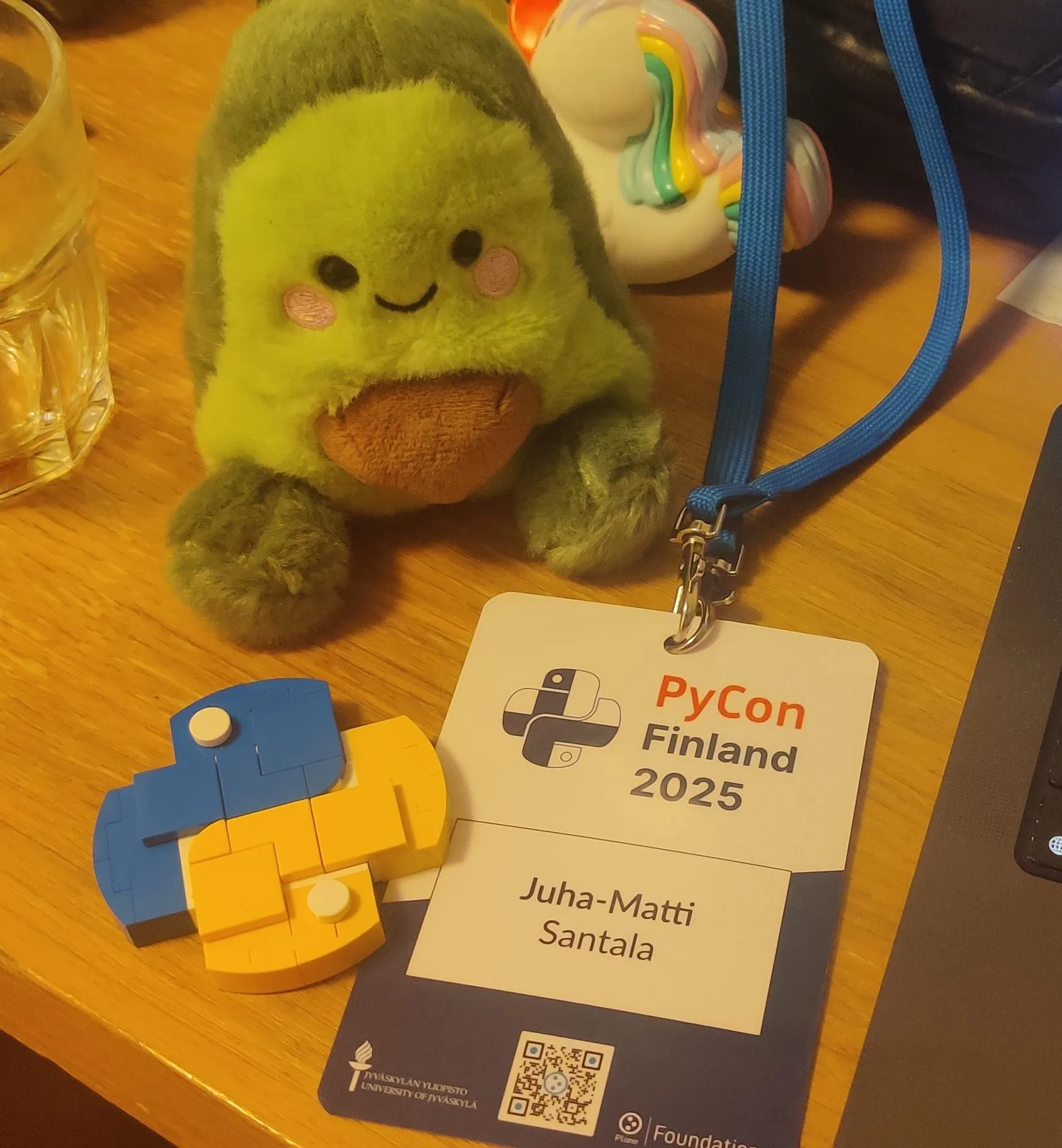 An avocado plushie, Python logo built from LEGOs and a PyCon Finland 2025 badge of Juha-Matti Santala 