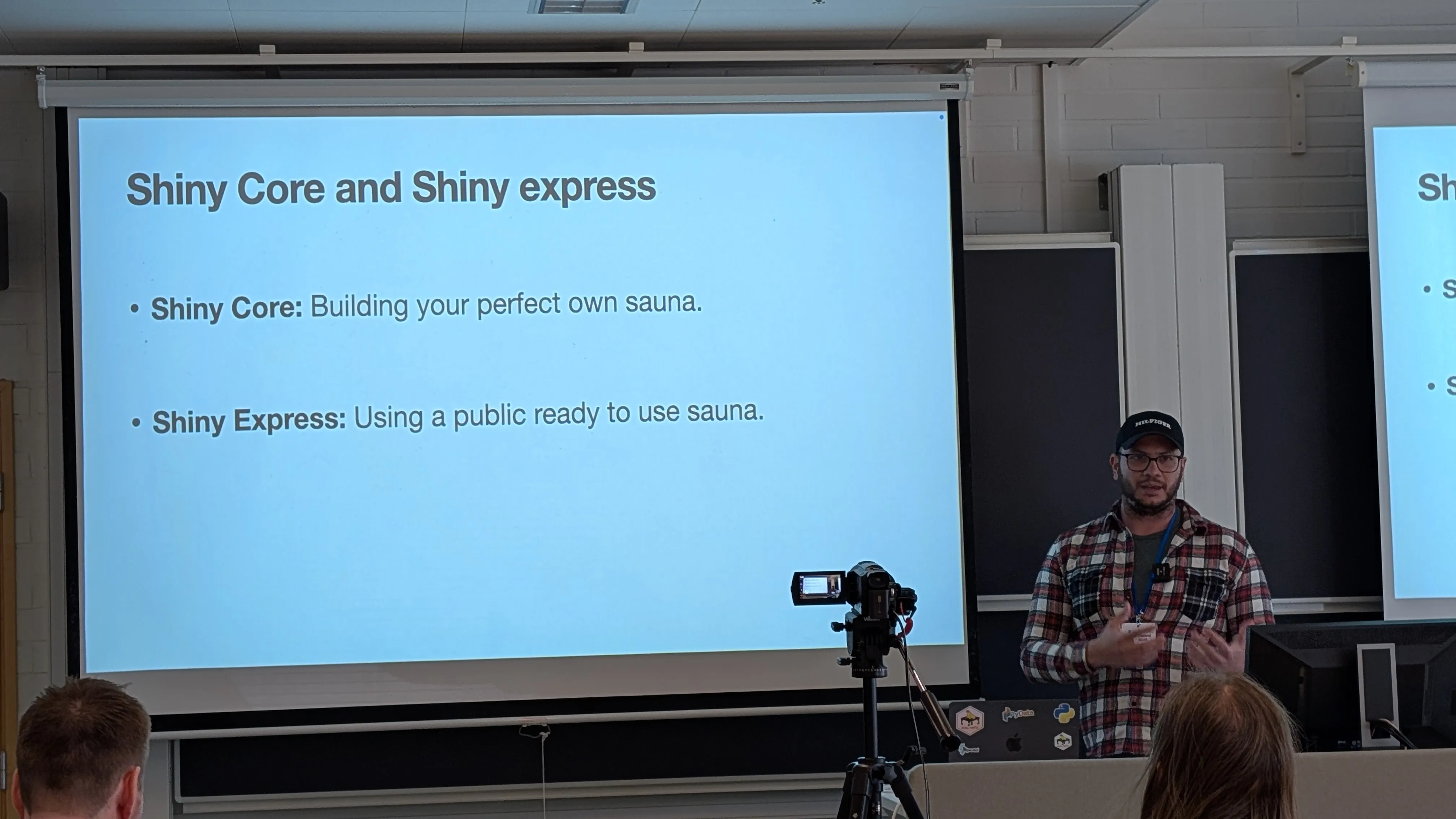 Fodil speaking in front of a room with a slide that reads: Shiny Core and Shiny express. 