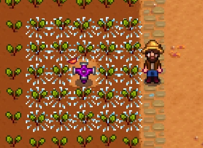 Screenshot of Stardew Valley with an iridium sprinkler being activated and watering crops.