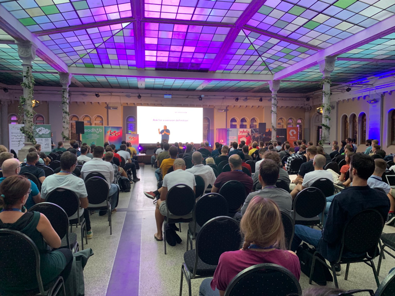 Me on a stage in front of a few hundred developrs sitting in the main hall of the conference